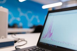 Laptop screen displaying a website analytics growth graph in an office