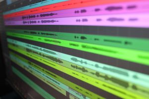 Close-up of colorful audio waveforms on a computer screen representing sound recording