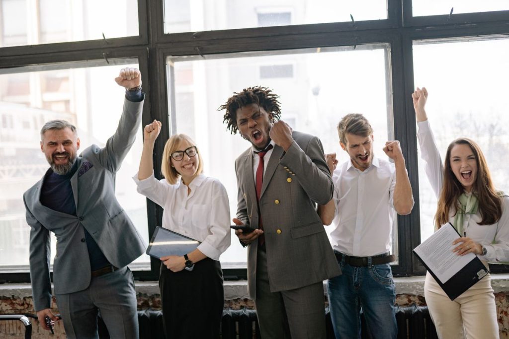 Small team celebrating together in the office